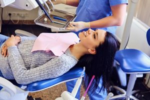 a lady is having restorative dental care