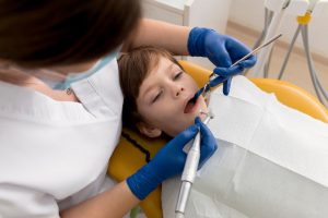a kid is getting dental treatment