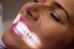 a lady is showing her teeth
