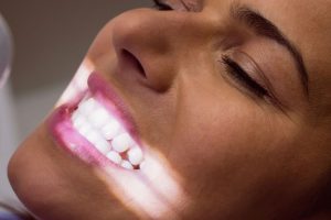 a lady is showing her teeth