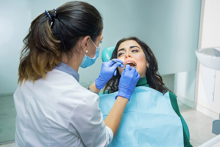 a lady visit's whitemud dental clinic and having restorative dentistry treatment