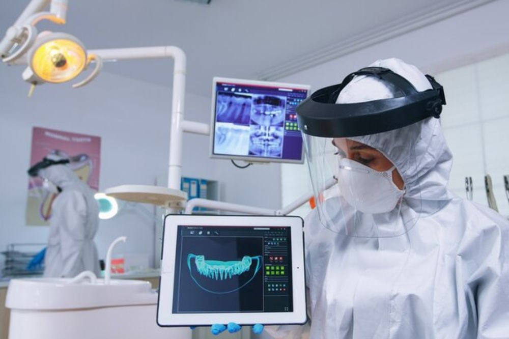 dentist reviewing a patient's dental report using technology
