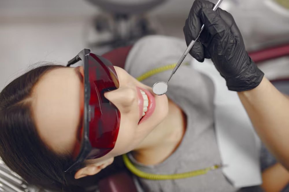 a female is having cosmetic dentistry treatment from dentist