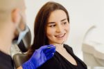 a lady is tallking to the dentist before getting dental crown treatment